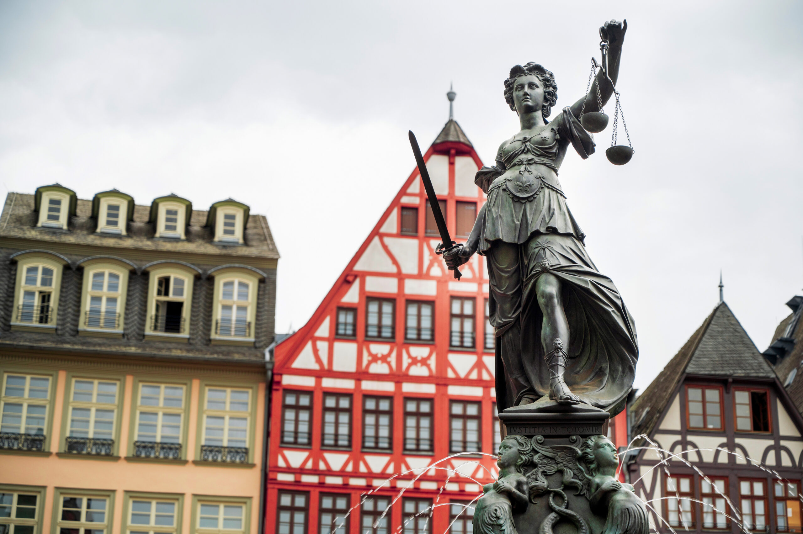 The Fountain Of Justice located in the Roemerberg, Frankfurt, Germany. Half-timbered buildings on the background
